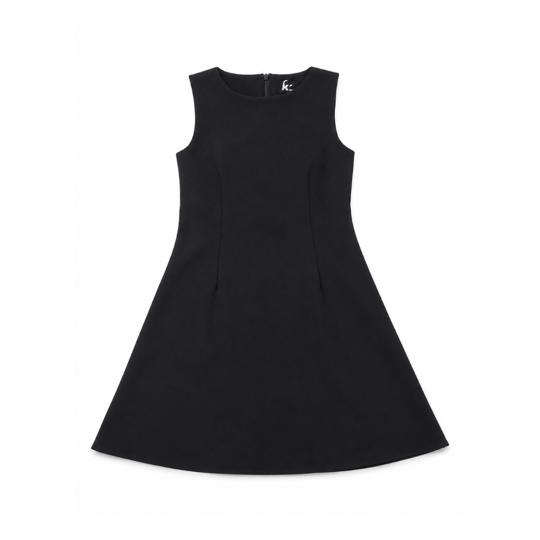 A black sleeveless A-line dress with a round neckline and a small white logo on the upper right chest, displayed flat against a solid white background at Scraps Of Magic Tween Boutique 