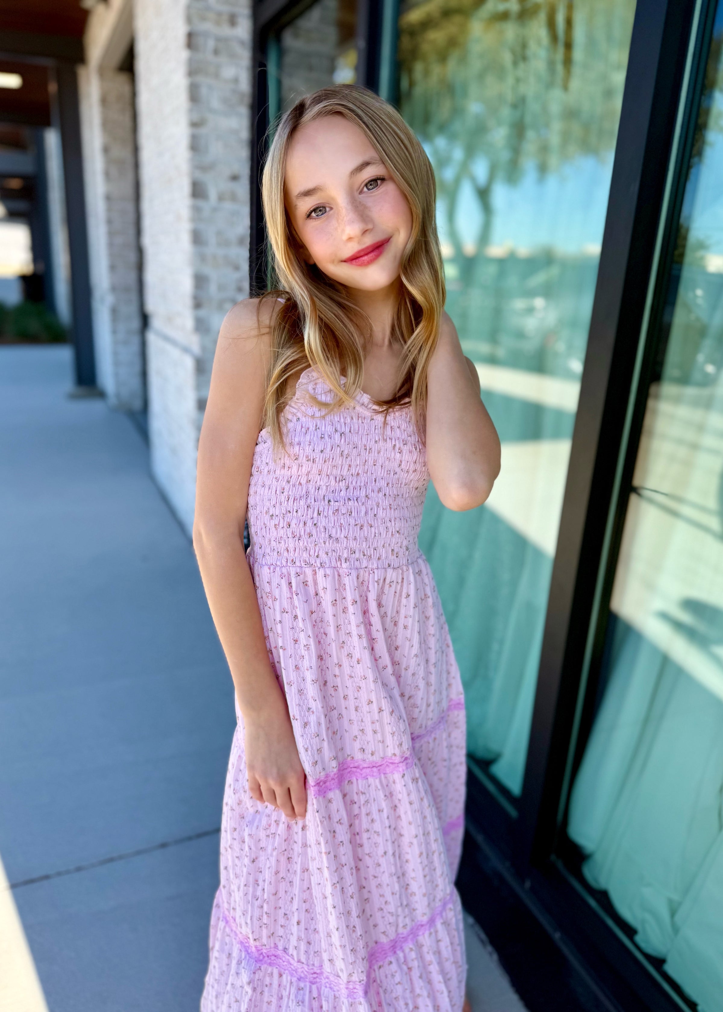 Tween girl wearing pink eyelet lace tiered maxi dress, modern age-appropriate style for girls"