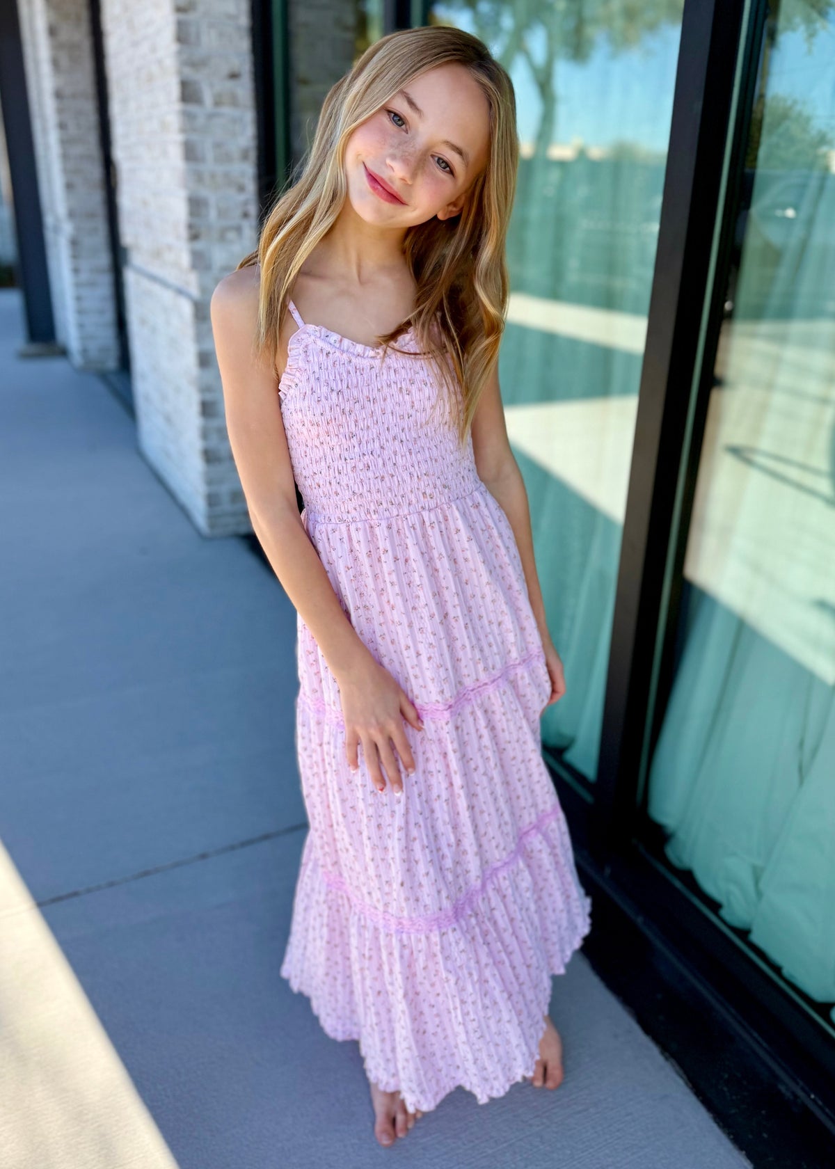 Tween girl wearing pink eyelet lace tiered maxi dress, modern age-appropriate style for girls"